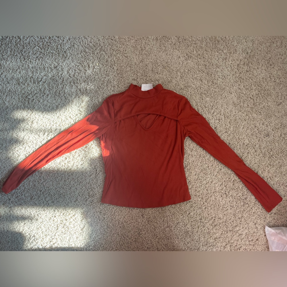 Medium orange top with small cutout on chest